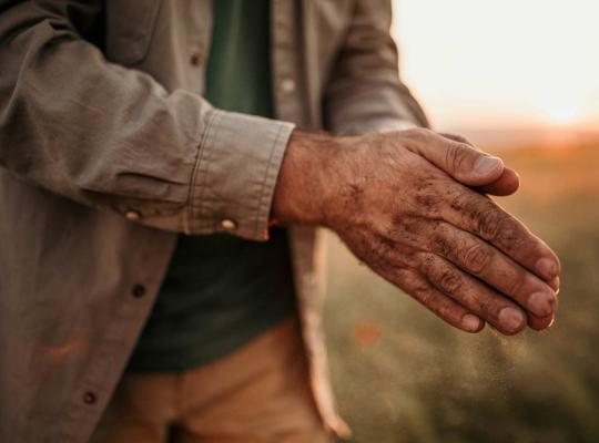 farmer rubbing hands together