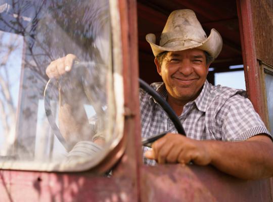 hispanic man driving traffic